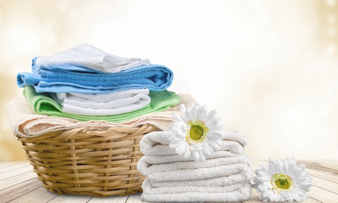 basket of clean folded laundry flowers on top of towels whirlpool WTW5000DW top-load washing machine 